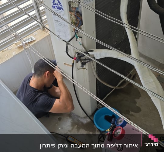 טכנאי עובד על מזגן עם כלים שונים